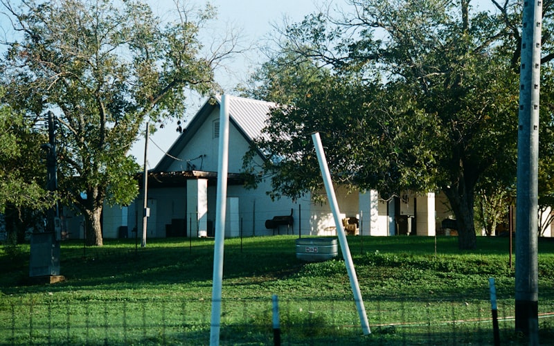 Beautiful white house with green lawn representing the homes we serve