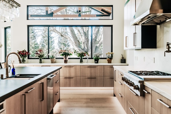 Modern kitchen with wood cabinets and large windows